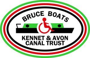 Bruce Boats (Kennet and Avon Canal Trust) Logo. The words "Bruce Boats" arched over a drawing of a canal boat with a wheelchair icon in the centre and Kennet and Avon Canal Trust in two straight lines underneath. All in an oval, with three thin lines surrounding - green on the outside, then red and black inside.